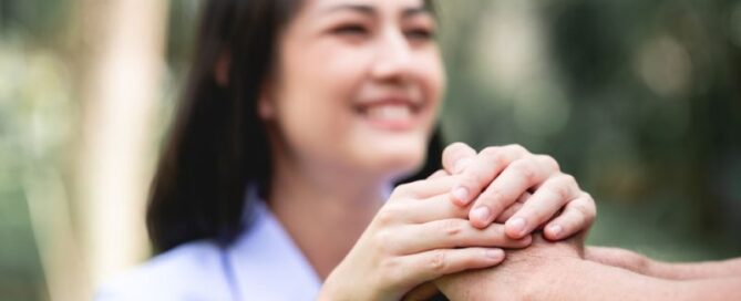 nursing holding patient's hand