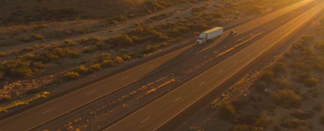 aerial view of a semi truck on the highway at sunset
