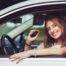 woman smiling in car with keys in her hand
